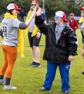 SOBC athlete high fiving motionball participant wearing colorful costume