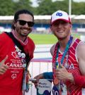 Peter holding a thumbs up with fellow athlete