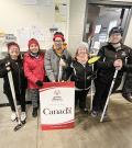 SOBC curling athletes group photo with Government of Canada sponsor sign
