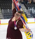 Kari Trott with silver medal, holding flag