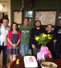 A group of people pose for a photo at a work party.