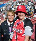 A police officer poses for a photo with an athlete