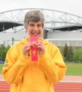 Brita holds ribbon won through Special Olympics.