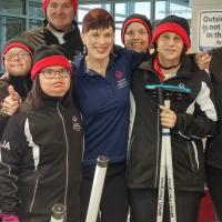 Marilyn smiling with group of SOBC athletes