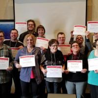 Athlete Leaders hold up certificates.