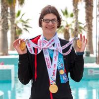 Kelsey Wyse smiling and wearing three World Games medals