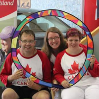 SOPEI Executive Director Charity Sheehan poses for a photo with two Special Olympics athletes.