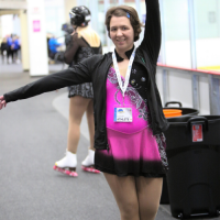 Victoria Sarty strikes a pose next to the rink