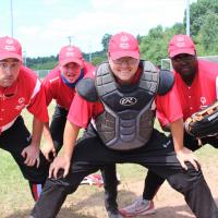 Softball players pose for a photo