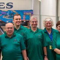 Maurice Bernier stands with his bowling team for a photo in front of the lanes.