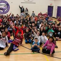 Special Olympics Ontario floor hockey team pose for group photo with middle school students who helped fund their trip to the Special Olympics Canada Winter Games Thunder Bay 2020.