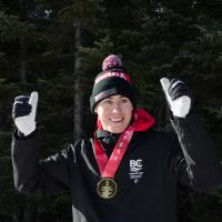 Francis Stanley gives two thumbs up with a medal around his neck