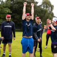 motionball athlete celebrating with hands in air with teammates cheering