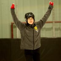 Tin-Yee skating with hands in the air