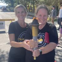 SOBC Athlete Reporter Sheenagh Morrison and law enforcement member Lisa Bruschetta holding torch