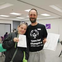 Two Healthy Athletes participants holding their certificates