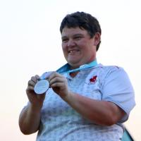 Erin Thom is all smiles as she receives her silver medal.