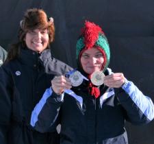 Patti Connors holds two medals at a Winter Games.