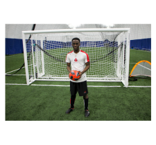 Eddie Nicks poses for a photo holding a soccer ball.