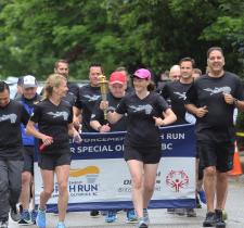 Officers run with the Flame of Hope and LETR signs