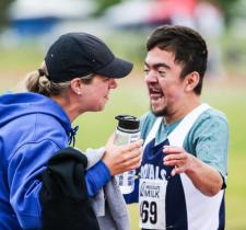 Kyla and a Special Olympics athlete hug at an event