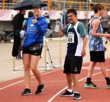 Kyla on the track with a Special Olympics athlete.