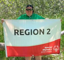 Roy Stephens holding the Region 2 banner