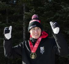 Francis Stanley gives two thumbs up with a medal around his neck