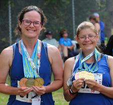 Athletes Ashley and Sheryl holding their National Games medals