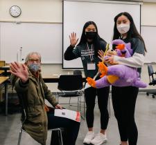 A Special Olympics athlete and volunteers wave at a Healthy Athletes screening