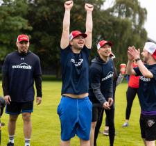 motionball athlete celebrating with hands in air with teammates cheering