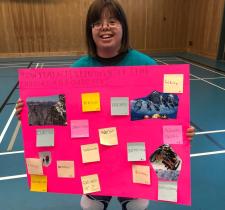 Claire Lemaire holding up poster that describes ways to stay active in the winter