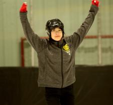 Tin-Yee skating with hands in the air