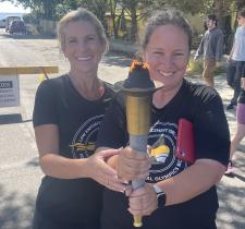 SOBC Athlete Reporter Sheenagh Morrison and law enforcement member Lisa Bruschetta holding torch