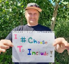 SOBC Comox Valley athlete holding #IChooseToInclude sign