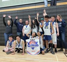 Port Moody Secondary student-athletes celebrating their first-place finish holding up their medals and banner