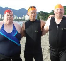 Peter with two other SOBC athletes, all in swimsuits at beach in Vancouver