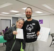 Two Healthy Athletes participants holding their certificates
