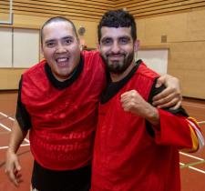 Two SOBC basketball players smiling and side-hugging