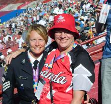 A police officer poses for a photo with an athlete