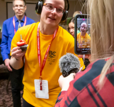 Special Olympics athlete, Adie, holds onto cupcake during birthday serenade.