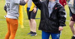 SOBC athlete high fiving motionball participant wearing colorful costume