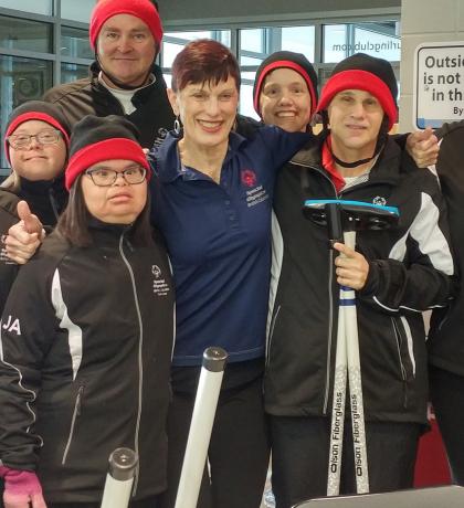 Marilyn smiling with group of SOBC athletes