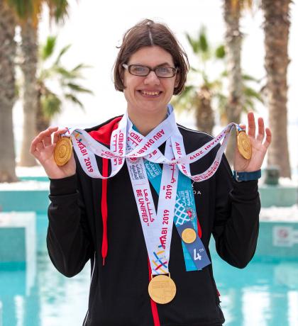 Kelsey Wyse smiling and wearing three World Games medals