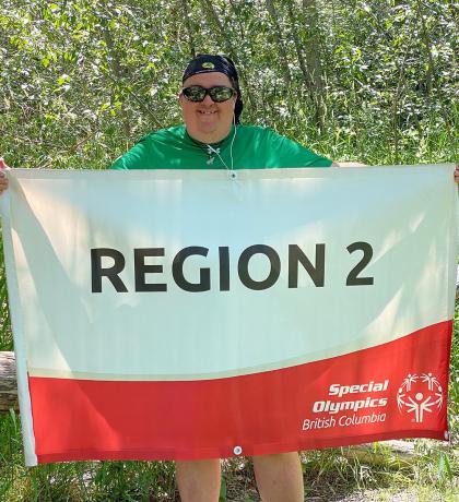 Roy Stephens holding the Region 2 banner