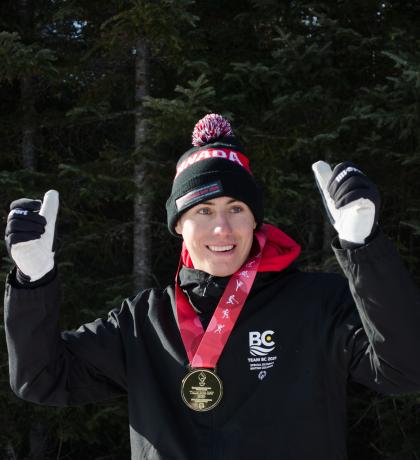 Francis Stanley gives two thumbs up with a medal around his neck