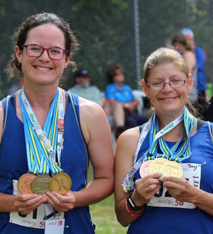 Athletes Ashley and Sheryl holding their National Games medals