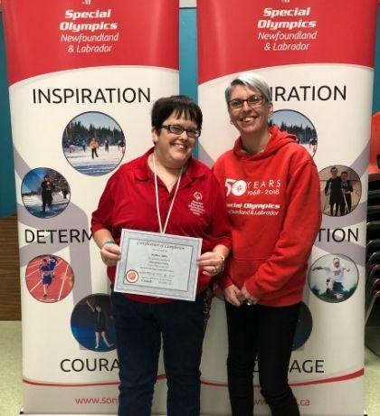 SONL Athlete Leader Heather Miller (CBS Brightstars Club) receiving a Athlete Leadership Certificate from SONL Program Director, Kim McDonald-Wilkes (she/her) during the NL Athlete Leadership Summit held in 2019.