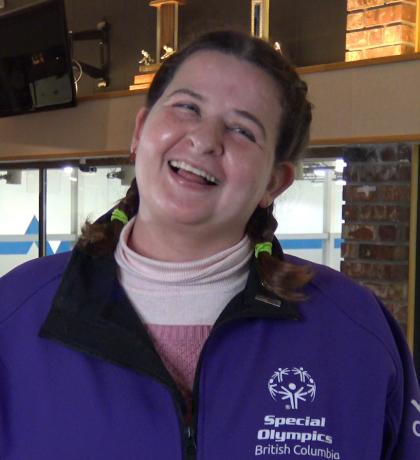 Athlete Bridget smiling at a curling practice