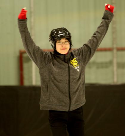 Tin-Yee skating with hands in the air